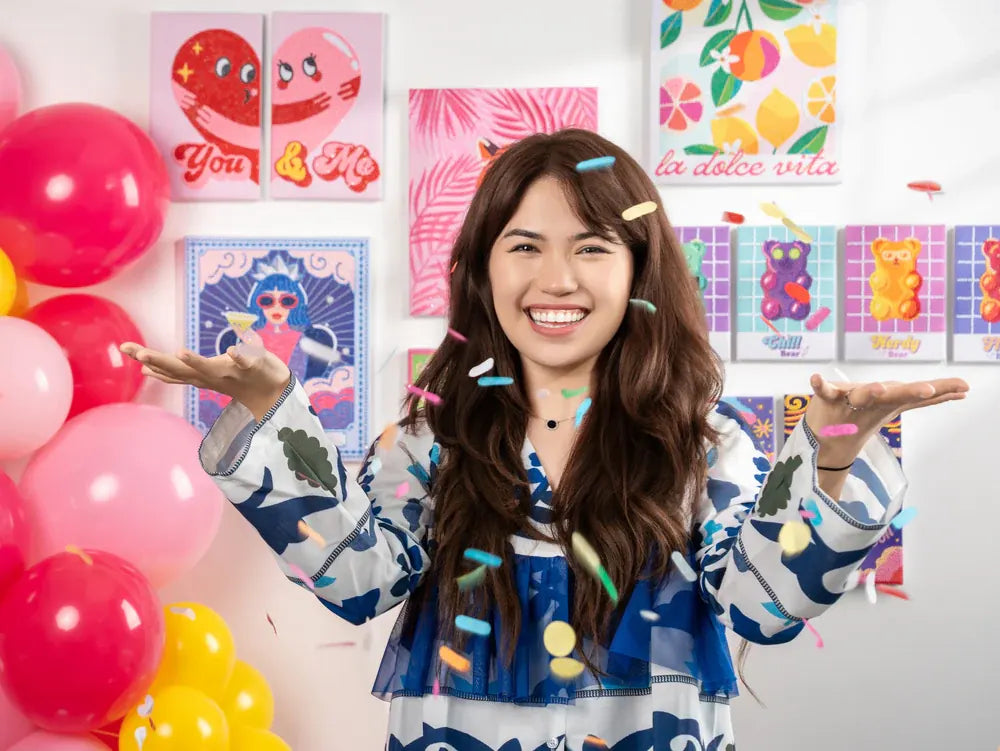 Mursal, founder of House of Party, surrounded by colorful balloons and confetti
