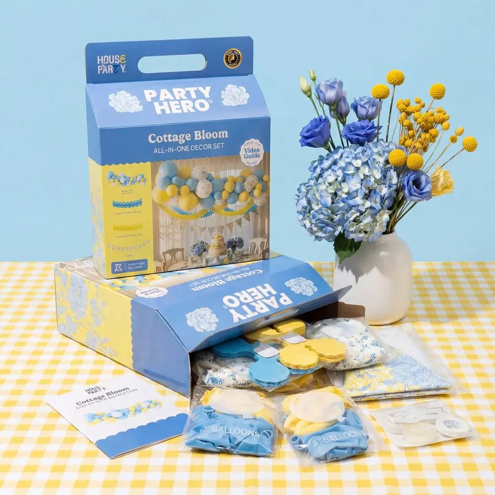 Coordinated Cottage Bloom Party Hero and Table Hero kits in their blue retail boxes