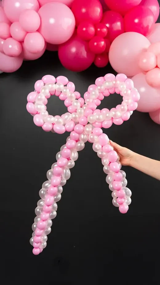 A giant bow made from pink balloons